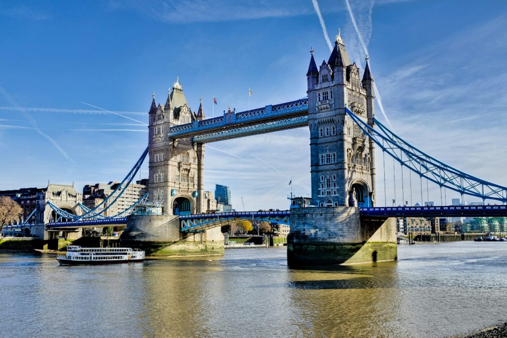a bridge with towers and a boat